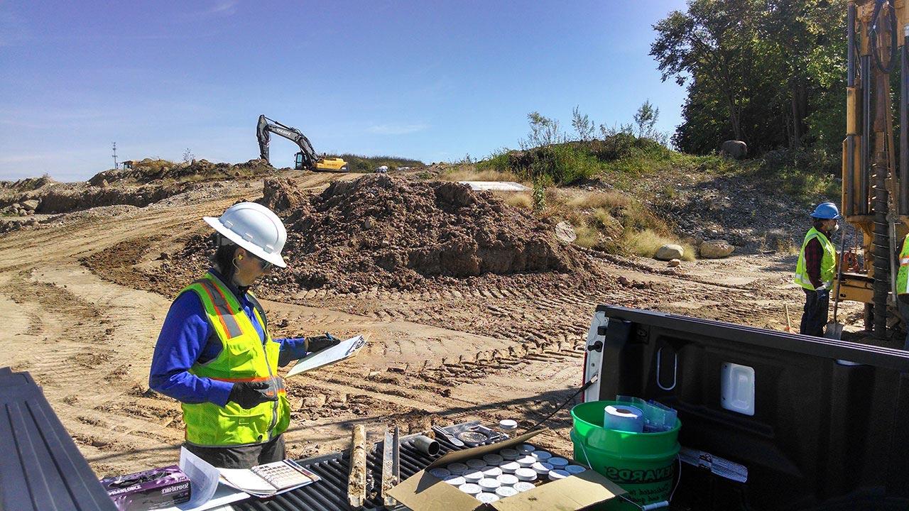 People standing at a site where soil boring drilling is being conducted in Glacier Ridge Landfill, Wisconsin